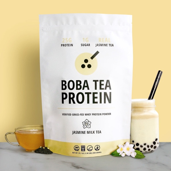 A clean, studio-lit shot of a Boba Tea Protein supplement bag accompanied by a glass of prepared tea to highlight product benefits.